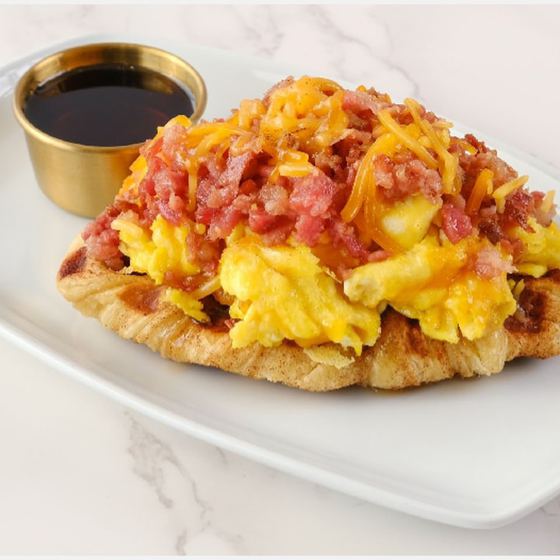 Bacon Me Crazy croffle with loaded eggs, bacon and cheddar