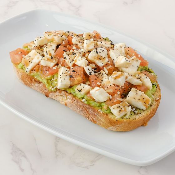 Sunset avocado toast with fresh mozzarella and tomato
